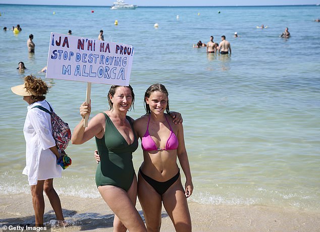 Members of the Mallorca Platja Tour association demonstrate against the tourist saturation on the beach of Palma de Mallorca