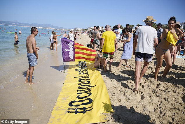 Protesters protest against tourism on the beach of Palma de Mallorca on August 11