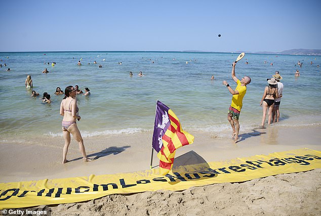 Members of the Mallorca Platja Tour association demonstrate on August 11 against the tourist crowds on the beach of Palma de Mallorca