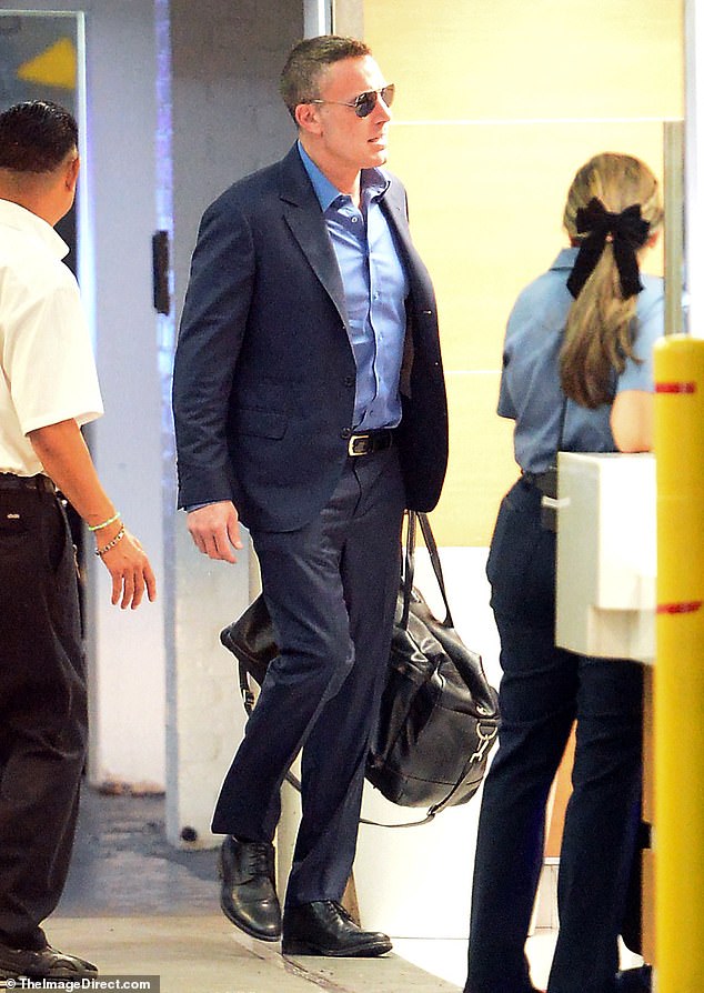 The Air actor, who turns 52 on Thursday, appeared to be in high spirits as he wore a navy suit with dress shoes and a black gym bag