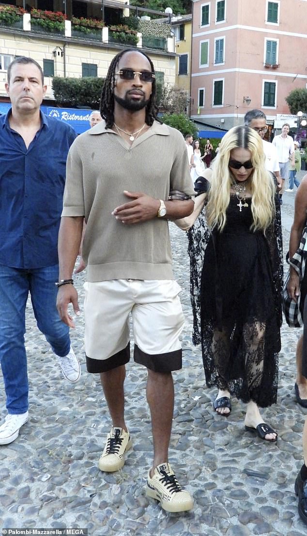 The pop icon, 65, held 28-year-old Akeem's arm as they took in the sights in Portofino, Italy