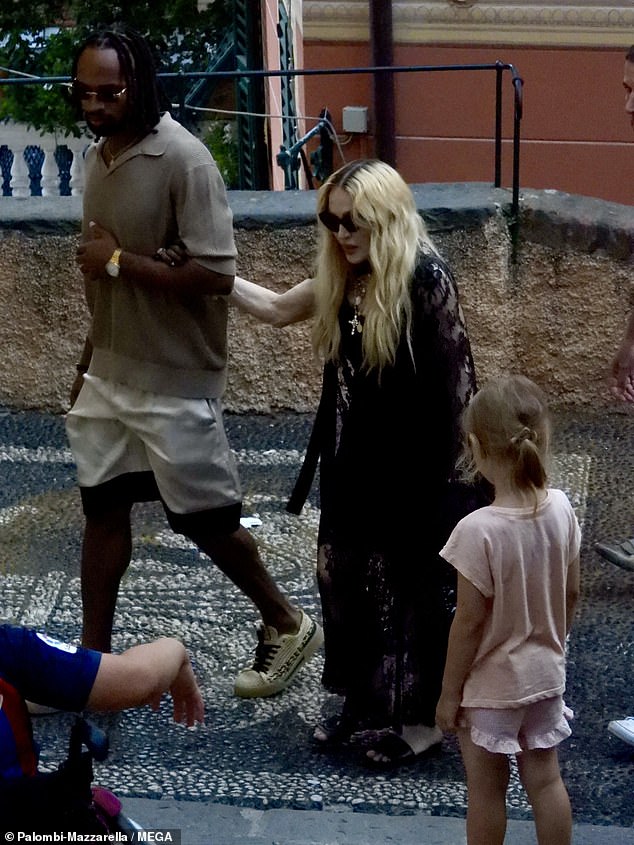 Madonna is seen holding Akeem's arm during their outing on Tuesday