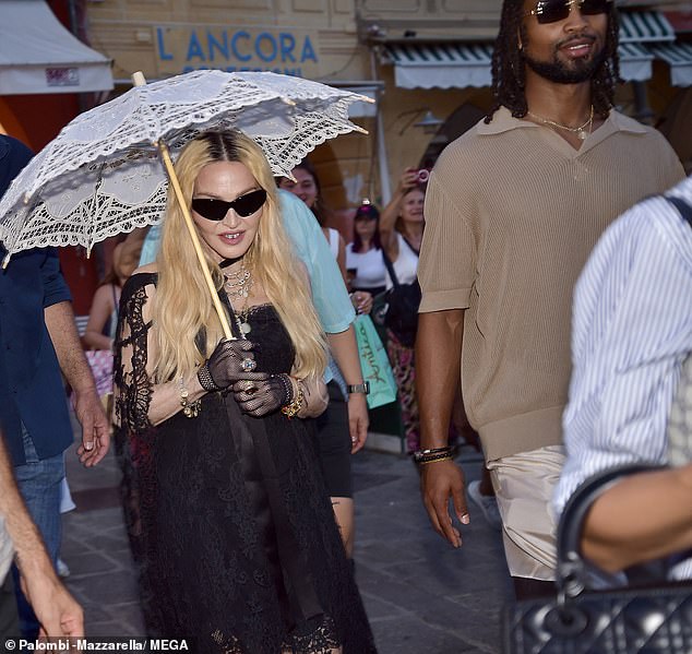 Madonna beamed next to her boyfriend as they walked to the restaurant