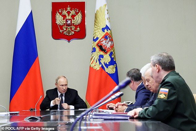 Russian President Vladimir Putin (left) chairs a meeting on the situation in the Kursk region at his residence in Novo-Ogaryovo outside Moscow, August 12, 2024