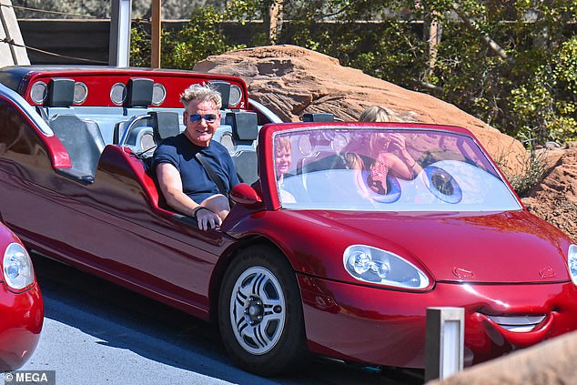 Gordon sat in the front seat of a red car next to Oscar, who was hugging a cuddly version of the Monsters Inc. character Boo.