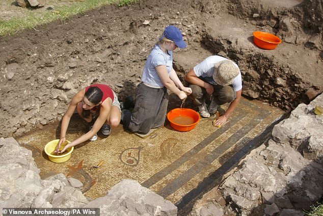 In the photo, archaeologists are busy cleaning the astonishing mosaic, which is said to have been commissioned by 'a rich and important person' at the Roman settlement.