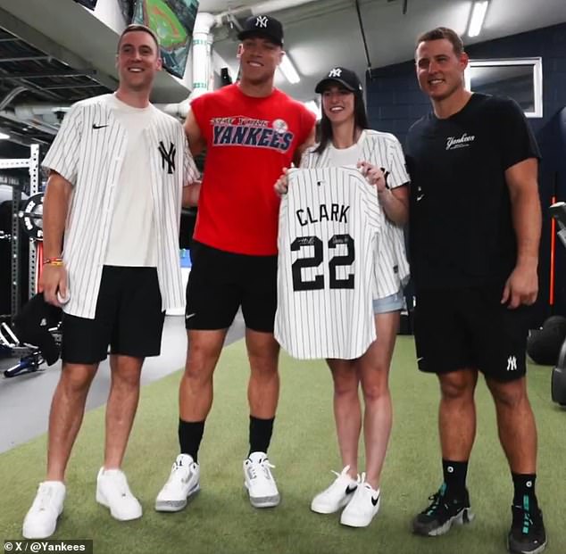 The WNBA star posed for photos with Aaron Judge (center), who gave her a Yankees jersey with number 22 as a gift