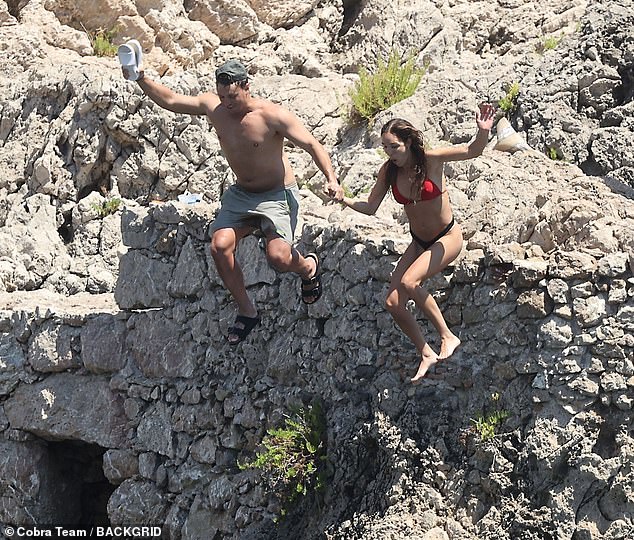 The couple took part in some daring activities during the day out, as they were spotted jumping off a cliff into the ocean