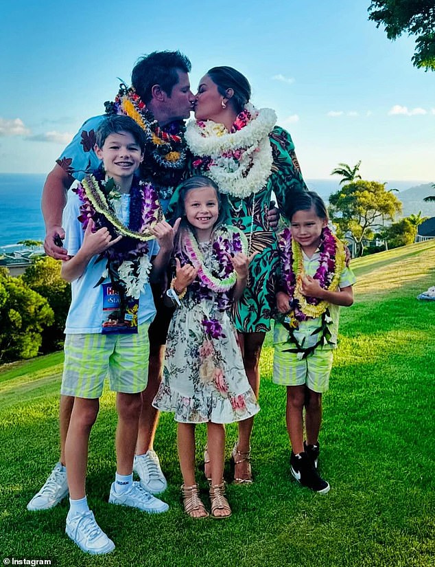 She shared a carousel of photos of herself, her husband Nick, 50, and her children Camden John, 11, Brooklyn Elisabeth, 9, and Phoenix Robert, 7, posing in Hawaiian ensembles and floral crowns