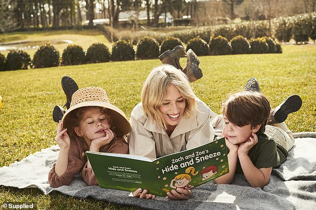 The mother-of-two has released a new children's book, Zach and Zoe's Hide and Sneeze, which aims to raise awareness of allergic rhinitis in children. Pictured: Phoebe (centre) with her daughter Poppy (left) and son Billy (right)