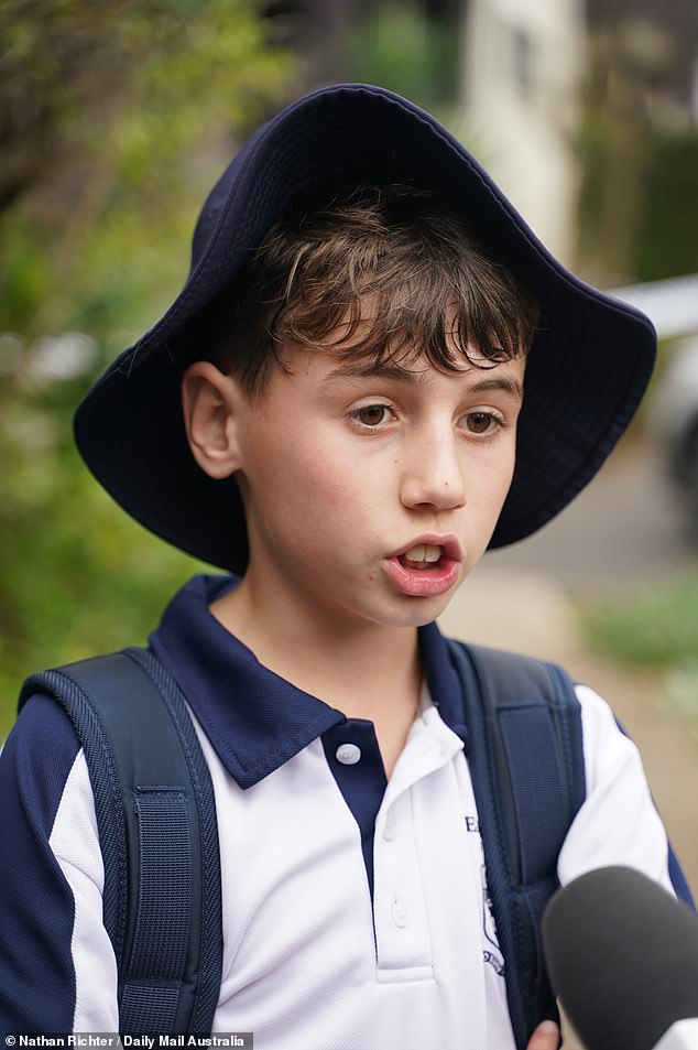 Sophie's classmate Oliver Hayes (pictured), 11, laid flowers outside her house on Wednesday afternoon with his mother and other school friends. 'She was one of the brightest kids in our school,' Oliver said