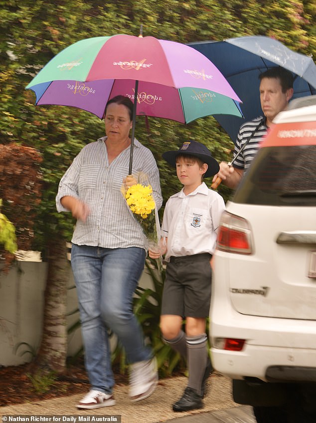 On Thursday morning, several children, accompanied by their parents, laid flowers at the crime scene on their way to school