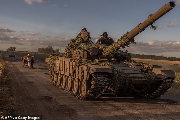 Ukrainian soldiers operate a Soviet-made T-72 tank in the Sumy region, near the border with Russia, on August 12, 2024, during the Russian invasion of Ukraine.