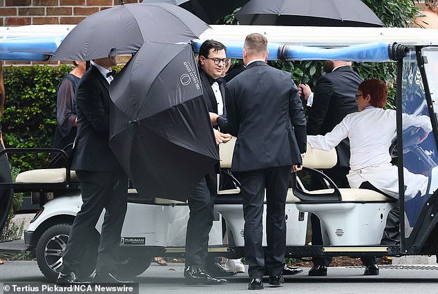 David Sharaz is pictured at his Gold Coast wedding in June, draped in umbrellas