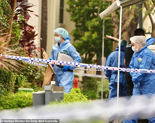 Police tape continues to block the residential street and a large forensic police car is parked outside the front door of the property as a team of officers entered and exited the suburban home on Thursday morning (photo)