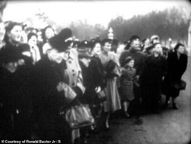 The footage shows a crowd of people waiting outside Buckingham Palace to catch a glimpse of the then Prince of Wales