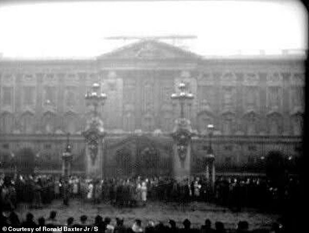 The rare footage shows clips of the crowd gathering outside Buckingham Palace