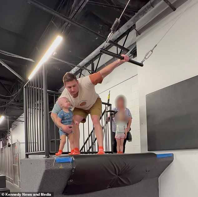 Jarrett Provo is pictured helping his daughter Reighlynn climb the trapeze