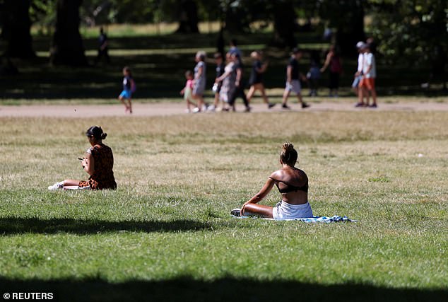 People sunbathe in London's Green Park on Tuesday during a heatwave