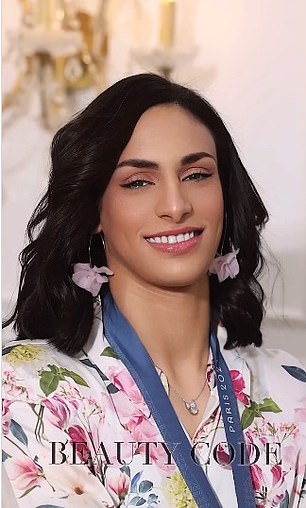 She poses in a pink floral dress with matching earrings