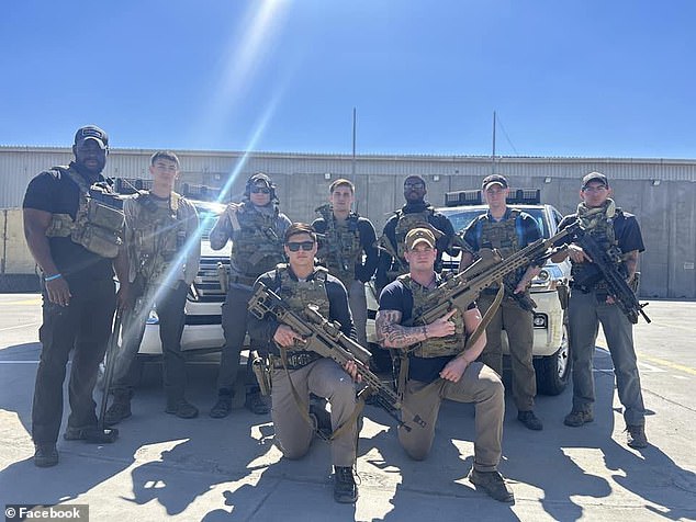 Jacob Ashton (right in photo, kneeling) is seen with his colleagues