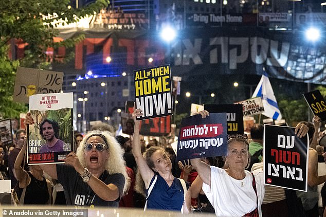 People protest in front of the Ministry of Defense building demanding the government sign a ceasefire and hostage exchange agreement on Thursday