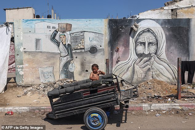 A boy sits in a trailer in a makeshift camp for displaced people in Gaza on August 13, 2024