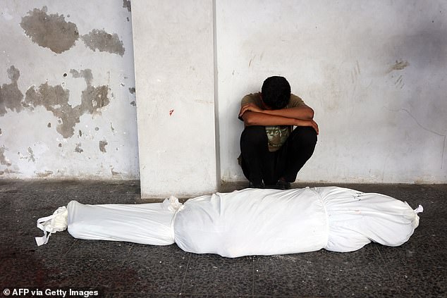 A man mourns the robe of a relative in Gaza City on August 10