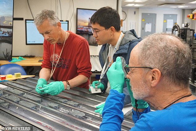 Lead researcher Johan Lissenberg of Cardiff University and two colleagues analyse the mantle rock sample. Their initial findings are already surprising.