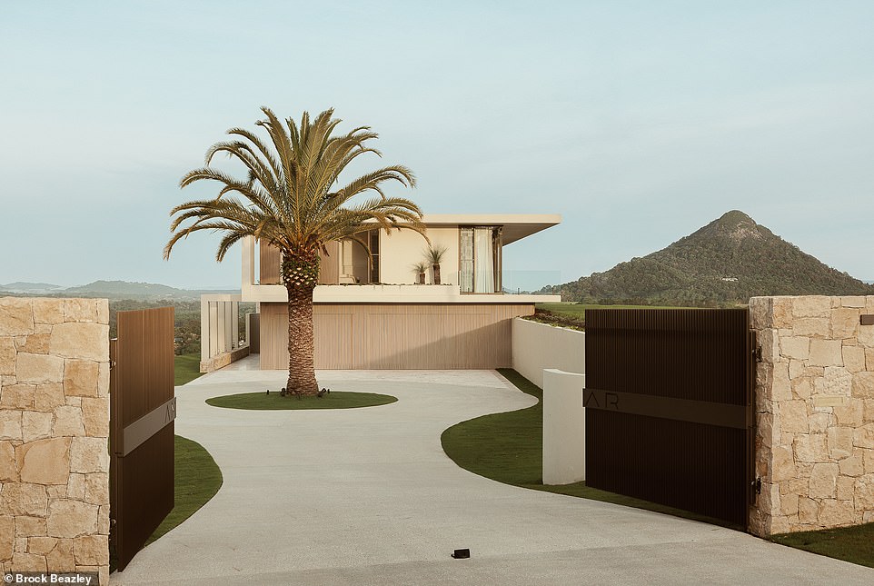 A striking date palm welcomes you as you drive up the circular driveway and take in the impressive structure of the house