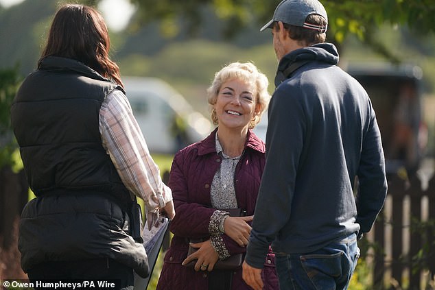 Sheridan wore a dark purple quilted jacket and a black and white patterned shirt for the filming in Shiremoor