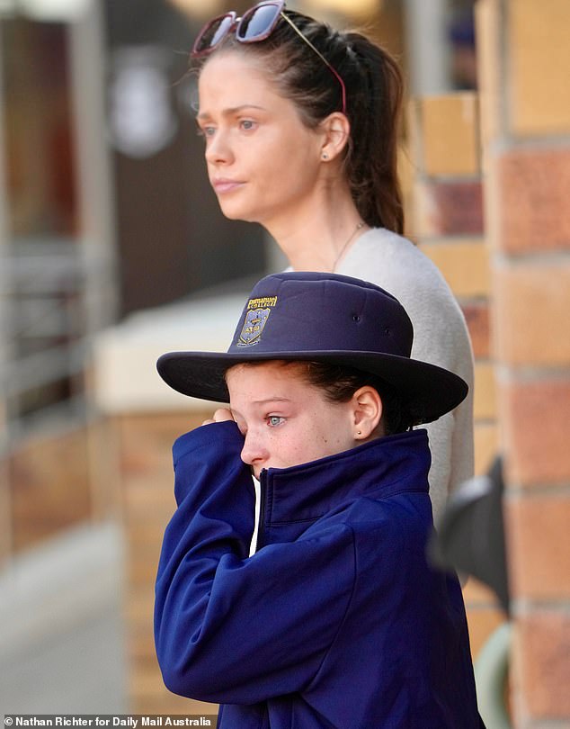 A young girl wipes away her tears after the death of fifth grade student Sophie Wang.