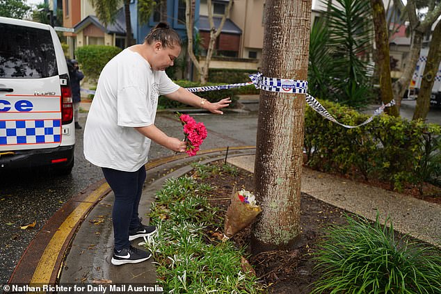 Heartbroken community members have left flowers at the scene of the alleged murder