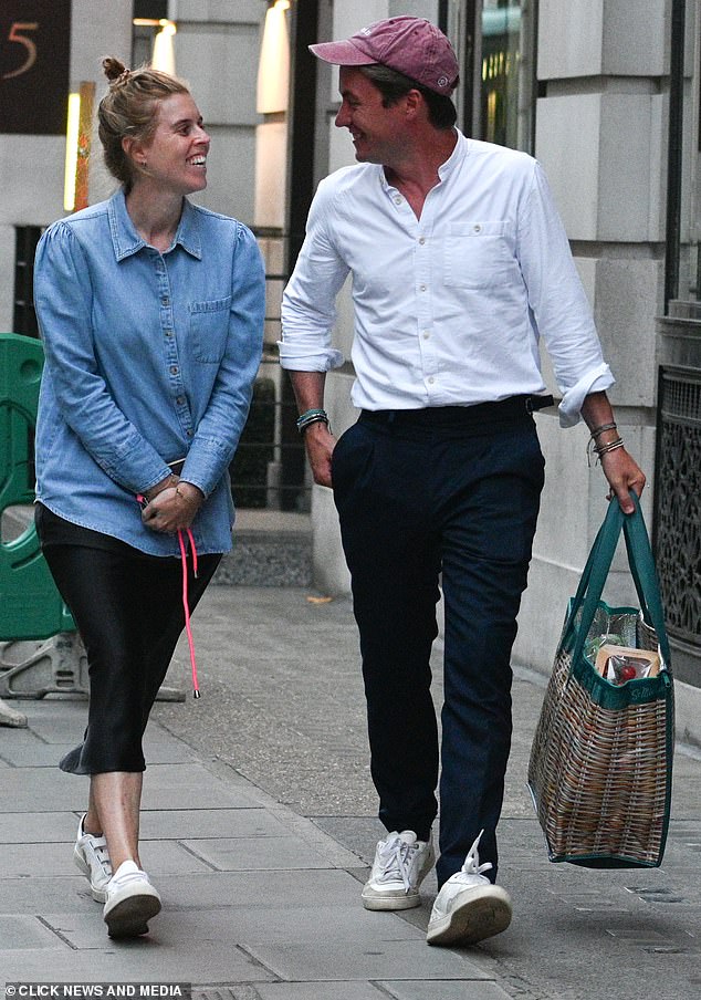 Beatrice - the daughter of Sarah Ferguson and Prince Andrew - wore a casual, oversized denim blouse and a black midi skirt