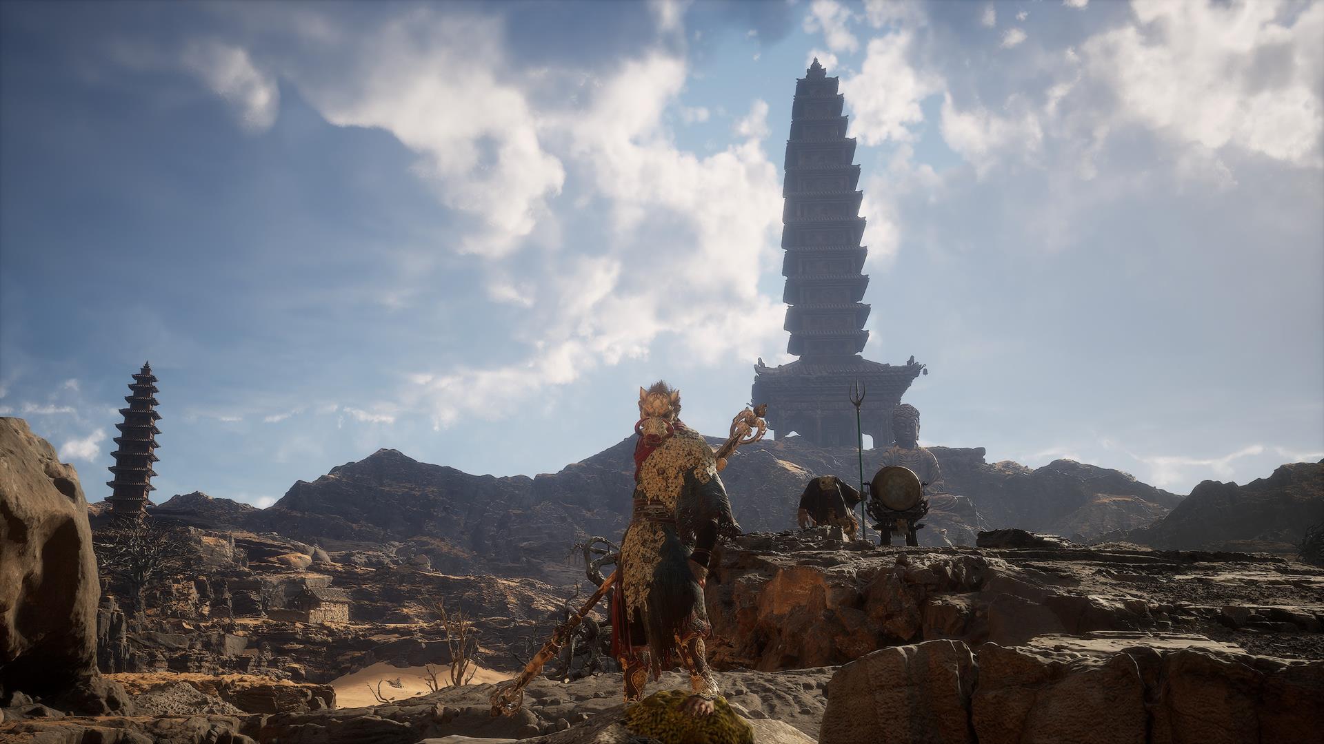 This image from Black Myth: Wukong shows the player standing on a sandy ridge, looking out over a large pagoda in a secret area known as the Kingdom of Sahali.