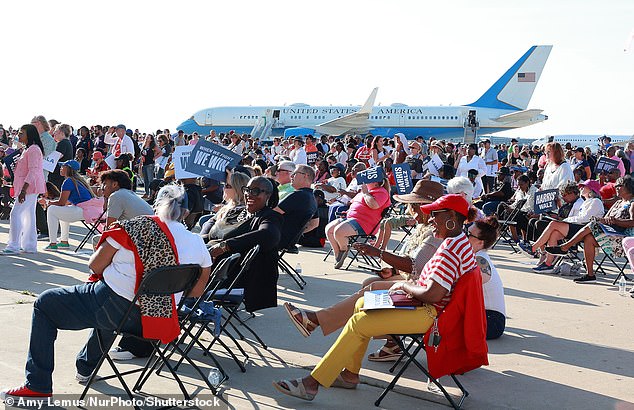 Supporters gathered on the platform outside the hangar, Air Force Two in the background attends a campaign rally with US Vice President and Democratic presidential candidate Kamala Harris