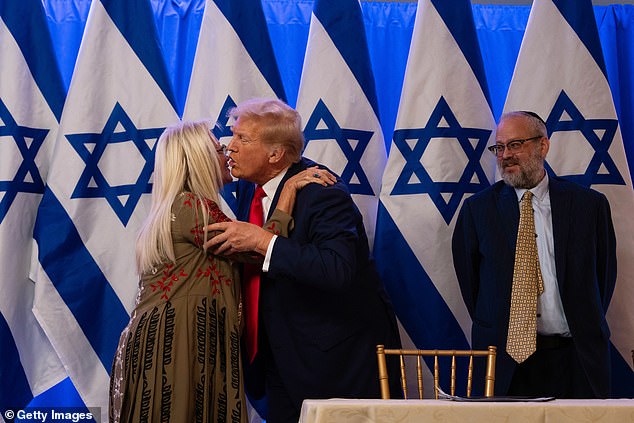 Former President Donald Trump (right) greets Miriam Adelson (left) during an event Thursday evening in Bedminster, New Jersey