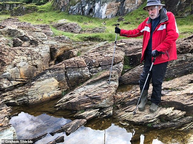 Anthony Spencer, co-author of the latest study, stands on glacial mortar (sediment deposited by a glacier) from the Port Askaig Formation on Garbh Eileach, the largest of Scotland's Garvellach Islands