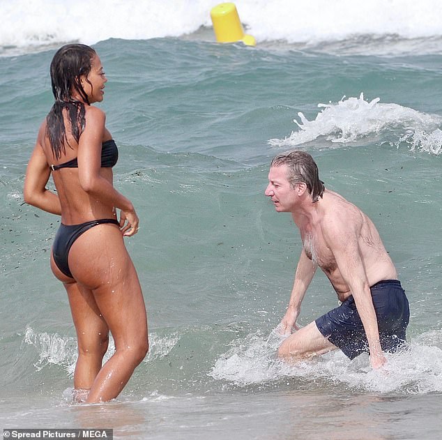 The stylish socialite beamed in the water as she took a dip with her husband to cool off