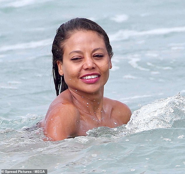 Emma cooled off with a dip in the ocean while the couple spent the day sunbathing on the beach