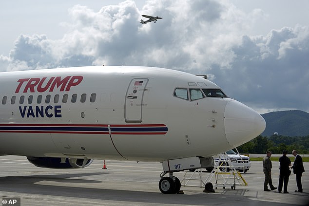 The plane is decorated with campaign details, including donor names on the tail