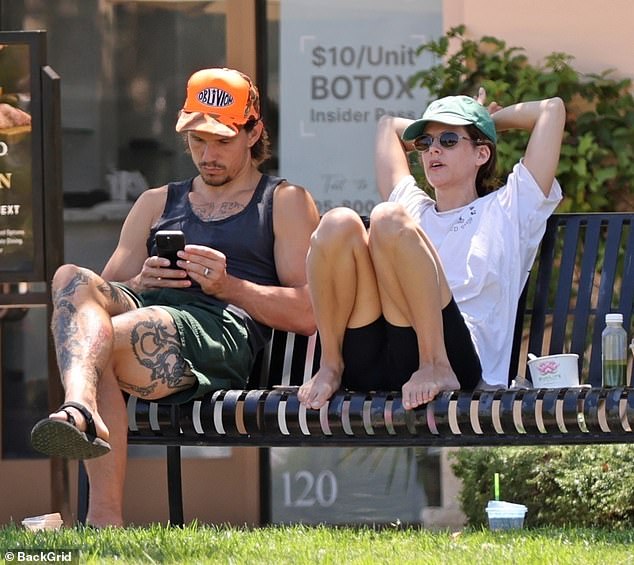 Dressed in a simple white T-shirt and black biker shorts, Elvis Presley's granddaughter sat barefoot, biting her lip as she sat on the bench