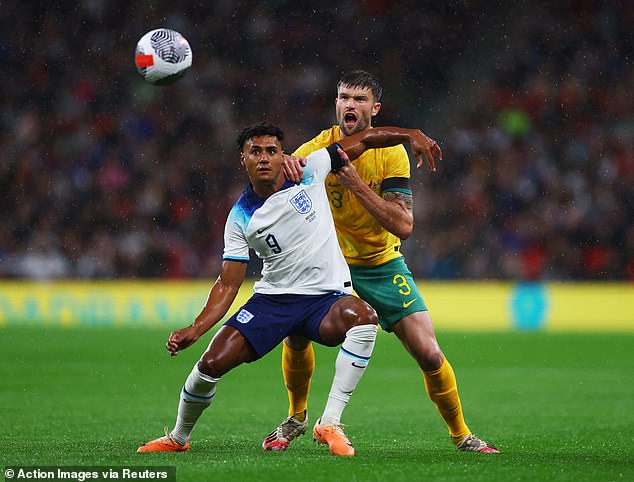 Australian Cameron Burgess, pictured wrestling with Englishman Ollie Watkins, is also an Ipswich Town squad member