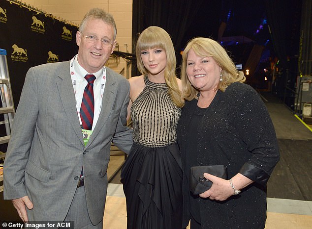 Taylor had revealed through tears that her parents watched as she tried to hold back tears during a thunderous three-minute applause from the audience (pictured with her parents Scott and Andrea in 2013)