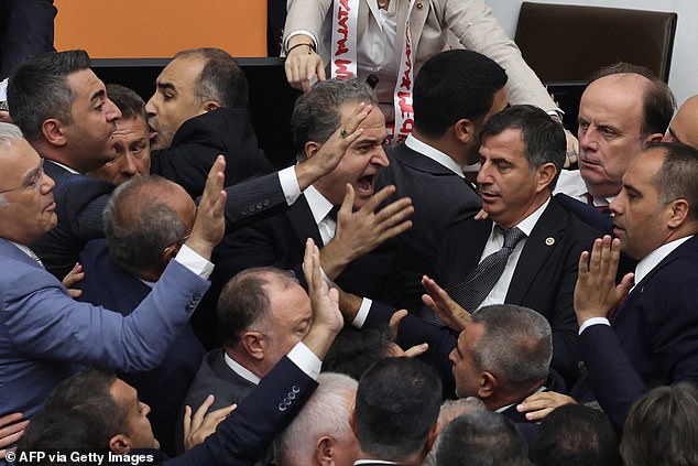 The shocking images from inside the Turkish parliament were broadcast on television as the brawl continued