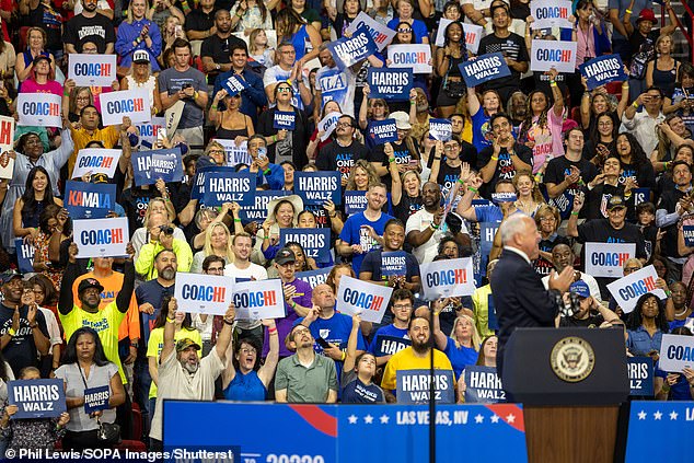 Supporters of Harris and Minnesota vice presidential candidate Gov. Tim Walz hold placards during campaign rally at the Thomas & Mack Center in Las Vegas