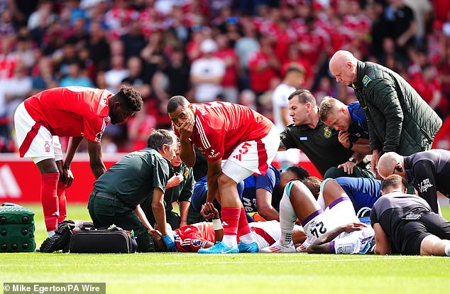 Teammate Murillo (center) pictured covering his mouth and looking away after taking a close-up look at Danilo's left leg