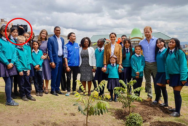 The shield was visible as the couple posed for photos with students at La Giralda School in Bogota's Santa Fe neighborhood