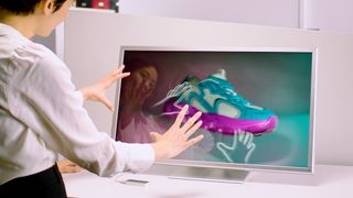 Looking Glass 32” spatial display on a table, where the user manipulates an image of a sneaker using gesture interaction.