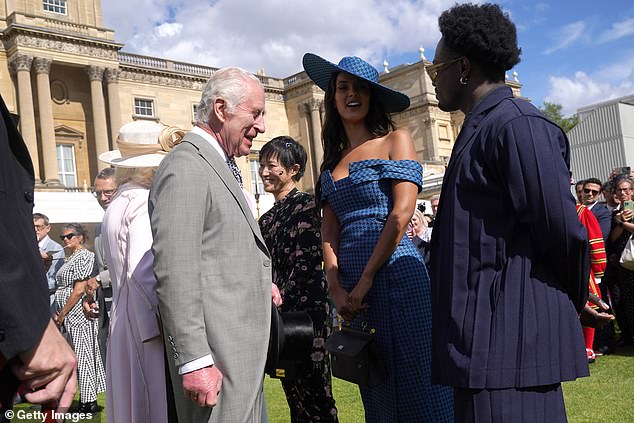 King Charles III speaks with Maya Jama and Campbell Addy at The Sovereign's Creative Industries Garden Party at Buckingham Palace on May 15